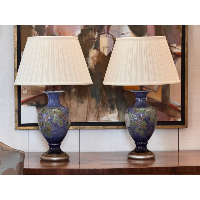 Pair of Royal Doulton lamps with baluster-shaped ceramic bodies decorated in raised relief with trailing rose and leaf...
