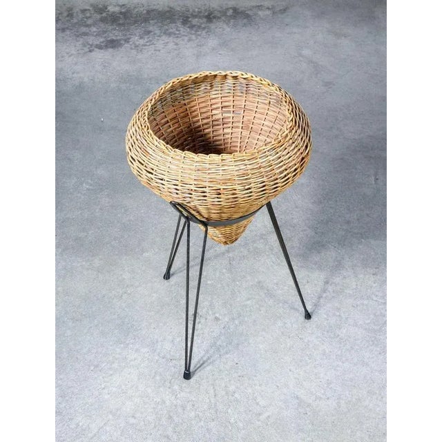 Vase holder, cachepot composed of a wicker basket and metal tripod structure origin italy period 1950s material wicker...
