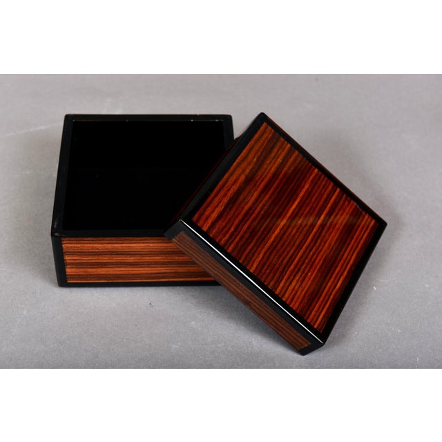 A high-gloss lacquered decorative zebra wood trinket box (for jewelry or other keepsakes) with a matching lid, striking...