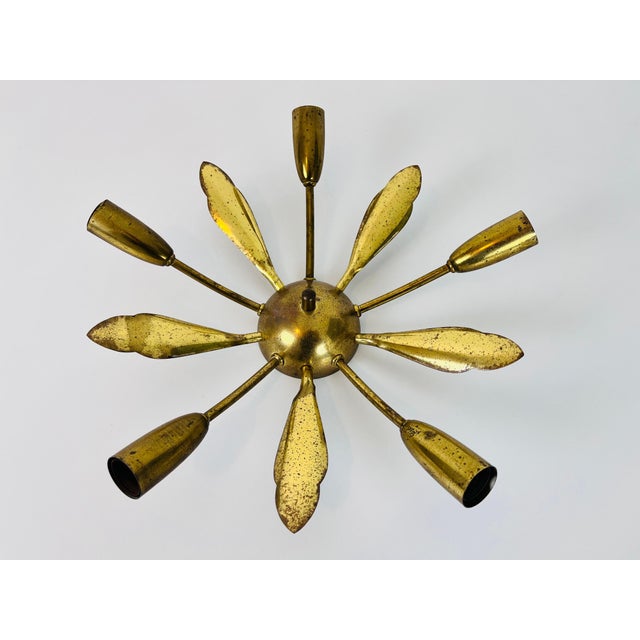 A brass Sputnik chandelier made in Germany in the 1950s. It is fascinating with its five brass arms, each of it with an...