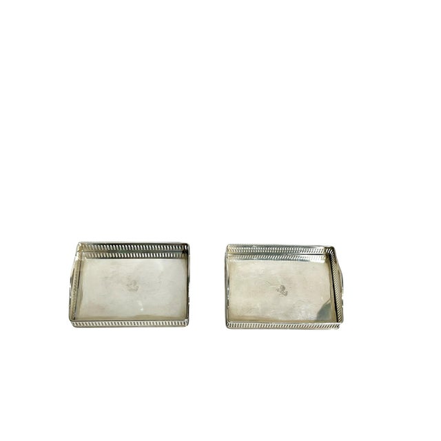 Petite matched pair of silver plate gallery trays by International Silver Company. Each tray has a horse and crown...