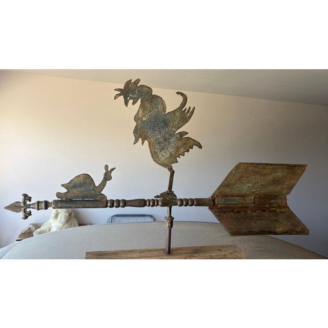 This folky rooster weather vane with a snail trailing behind.This hand made weather vane has a wonderful old aged...