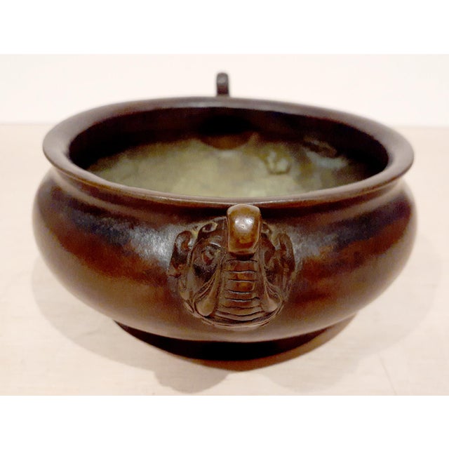 Chinese bronze elephant handles censer, a finely formed, circular, bronze bowl with tumescent sides and finely carved...