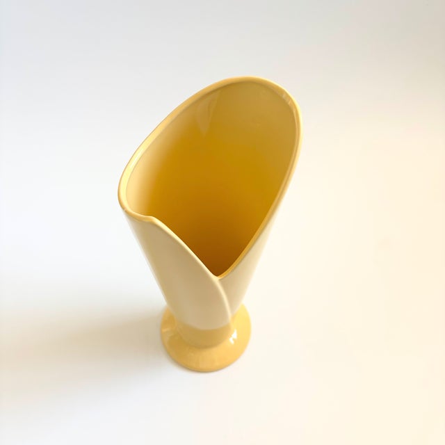 A vintage 80s postmodern ceramic vase. Unique wrapped design, finished in a glossy pale yellow glaze. Nice large versatile...