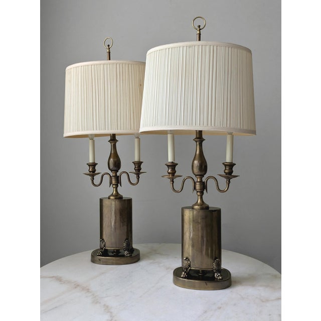 A monumental pair of aged brass table lamps attributed to Frederick Cooper, are an unmatched option and impossible to...
