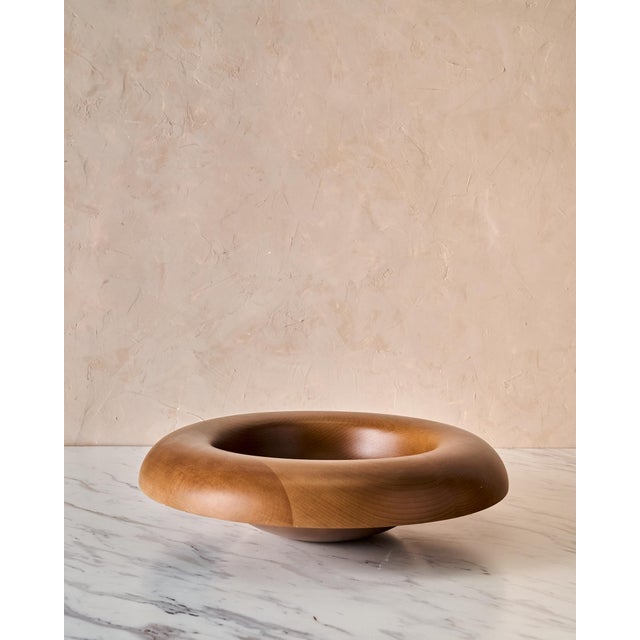 A sculptural oversized beech wood bowl designed by Colin King for Audo Copenhagen, celebrated for its architectural form...