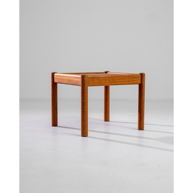 This minimalist Danish coffee table charms with the simple elegance of its outlines: sturdy round feet are attached to a...