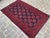 Enhance your living space with this vintage handmade Sarooq Afghan rug. Featuring an elegant geometric design in rich red...