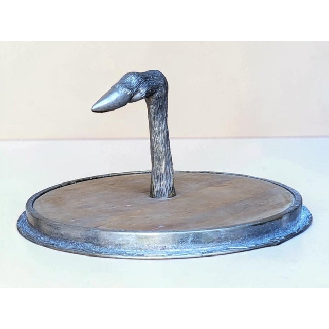 Cheese/charcuterie board. Wooden base with metal rim. Silver-plated metal handle in the shape of a boar's foot. No...