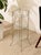 A wonderfully sculptural vintage side table featuring a slender metal framework designed to hold three graduated round...