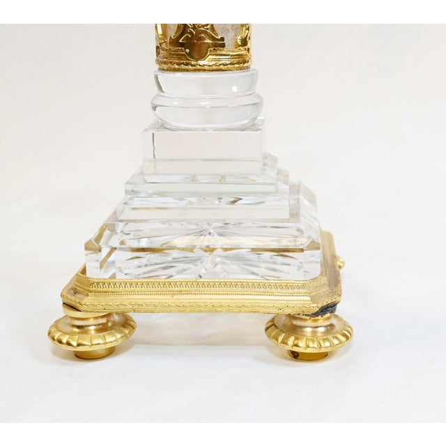 Pair of gilt and rock crystal candelabras in the Empire manner Classic high Empire with gilt pharaohs around the central...