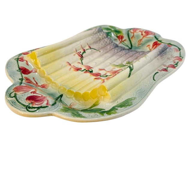 An early 20th century French barbotine / majolica asparagus serving platter from St. Clément. The colors are in a...