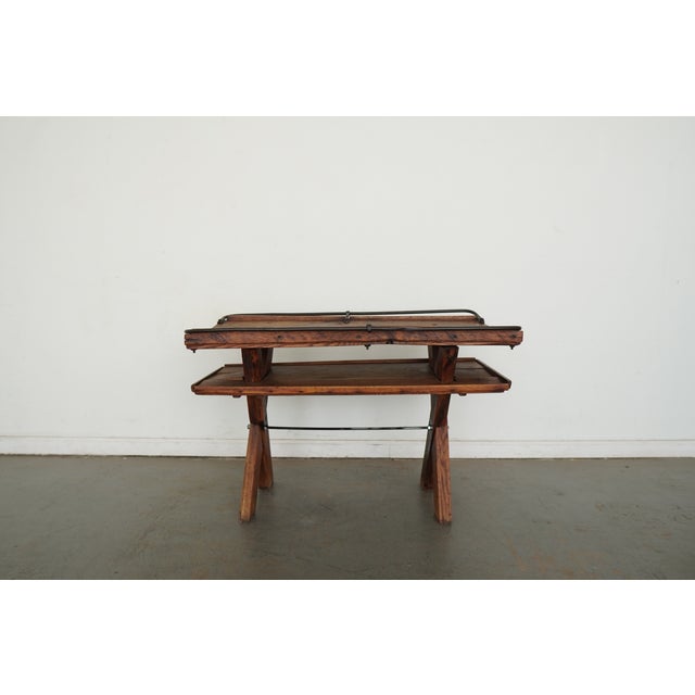 This vintage accent table is crafted from reclaimed wood, produced in the late 20th century using salvaged materials. The...