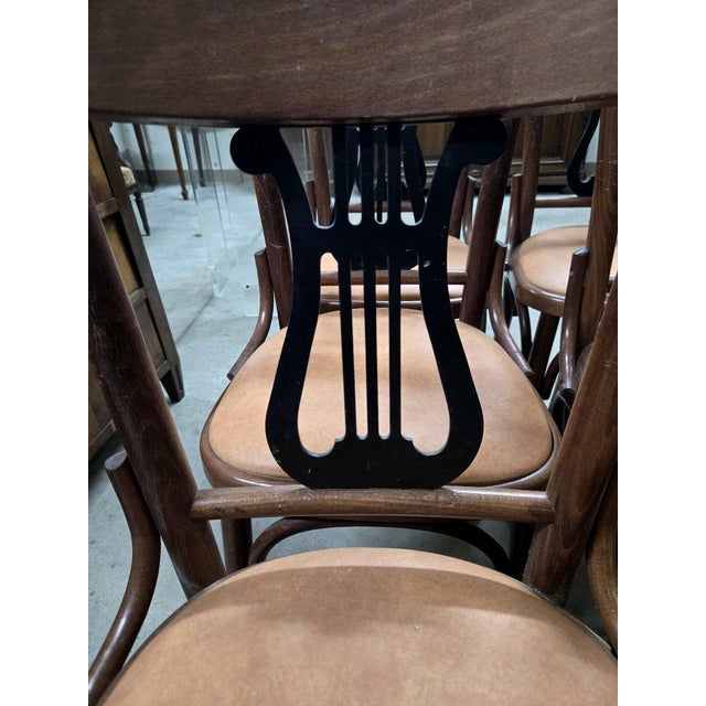 Set of 6 vintage bentwood chairs, each adorned with an elegant black lyre-shaped backrest. High-quality craftsmanship,...