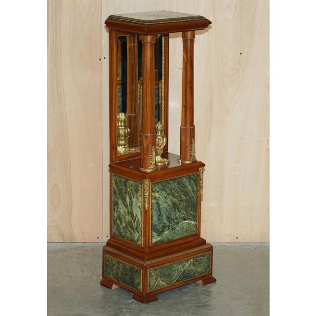 This exquisite pair of Walnut, Gold Gilt Bronze mounted pedestals with Italian Green marble tops and mirrored backs circa...