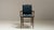 Made in England in the 19th century, this armchair pairs a dark, richly polished wood frame with a deep navy upholstered...