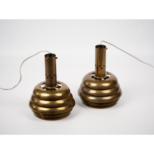 A pair of rare brass lamps from the 1950s. dimensions: diameter: 18cm height: 24cm the lamps are in very good condition,...