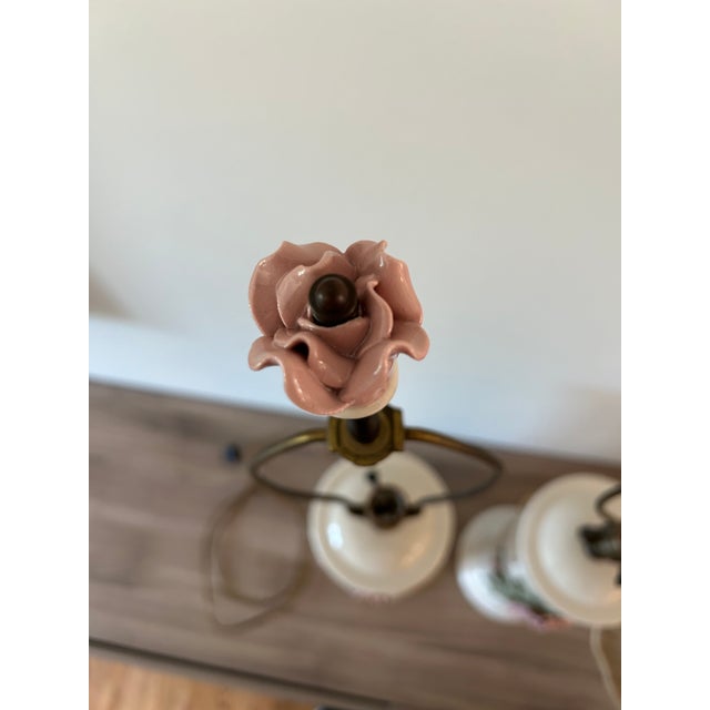 Lovely pair of vintage Marbro lamps. Beautiful soft pink porcelain roses and greenery on a soft white backround. Note that...