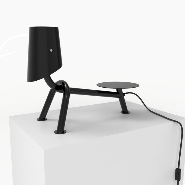 Carlino is a table lamp with a playful and ironic design, inspired by the cute shape of a Pug. Made of tubular iron and...