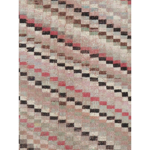 This mid-20th-century Turkish Anatolian accent rug presents a lively abstract composition formed from small checkerboard...