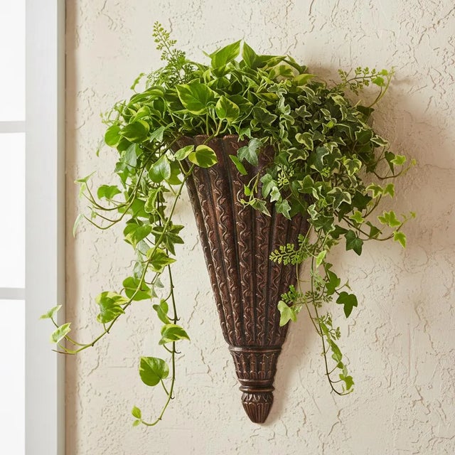 Dimensions: 11" W X 7" D X 19" H Add a touch of artistic charm to your walls with this beautifully handcrafted wall sconce...