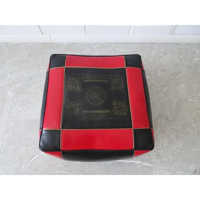 This square pouf from the 1970s is a Moroccan floor pillow, made of leather / synthetic leather with a straw filling....