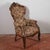 This impressive armchair features a richly carved solid wood structure, typical of the period style. The sinuous lines and...