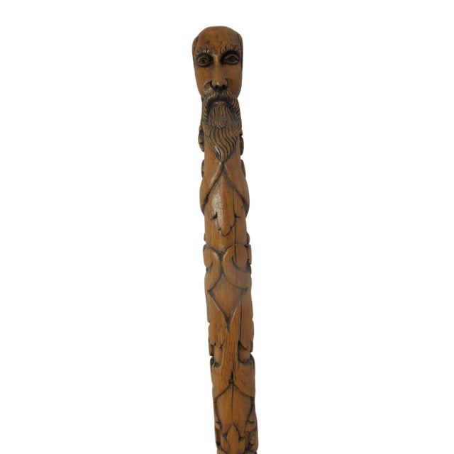 Antique, late 19th century folk art walking stick carved from a single piece of wood. The cane features an intricate,...