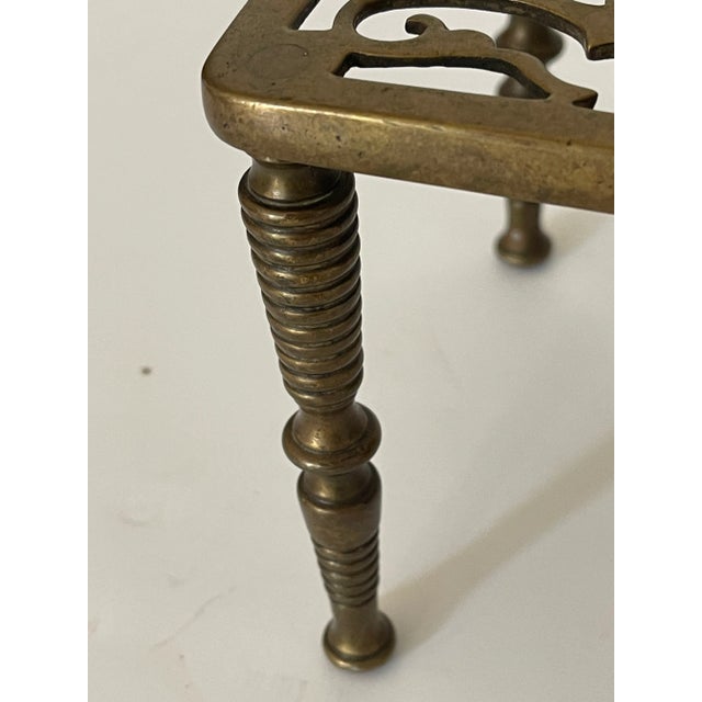 Antique ornate brass trivet.