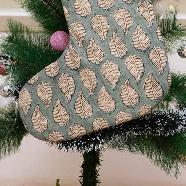Add festive charm to your home with this handmade block print stocking, crafted from a premium linen-blend fabric and...