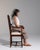 Lyre-back side chair in Rich Walnut Brown. The rich walnut brown surface highlights carved lyre splat, barley-twist front...
