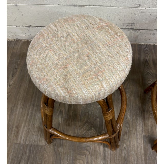 This is a gorgeous pair of vintage rattan and bentwood swivel bar stools featuring sculptural arched frames, wrapped...