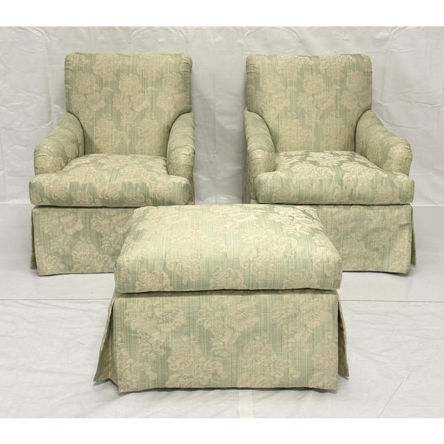 An elegant and exceptionally comfortable pair of vintage swivel lounge chairs with matching ottoman, manufactured by...