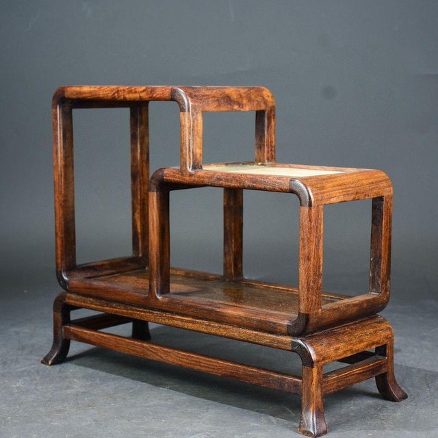 An exquisite vintage Chinese display stand (Bogu Jia) crafted from richly grained Huanghuali (rosewood) with a warm, aged...