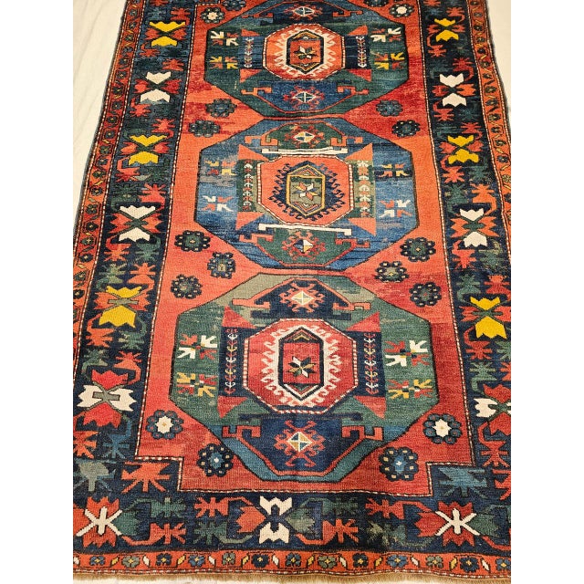 This exquisite late 19th century Caucasian Kazak rug features three striking medallions woven in vibrant abrash shades of...