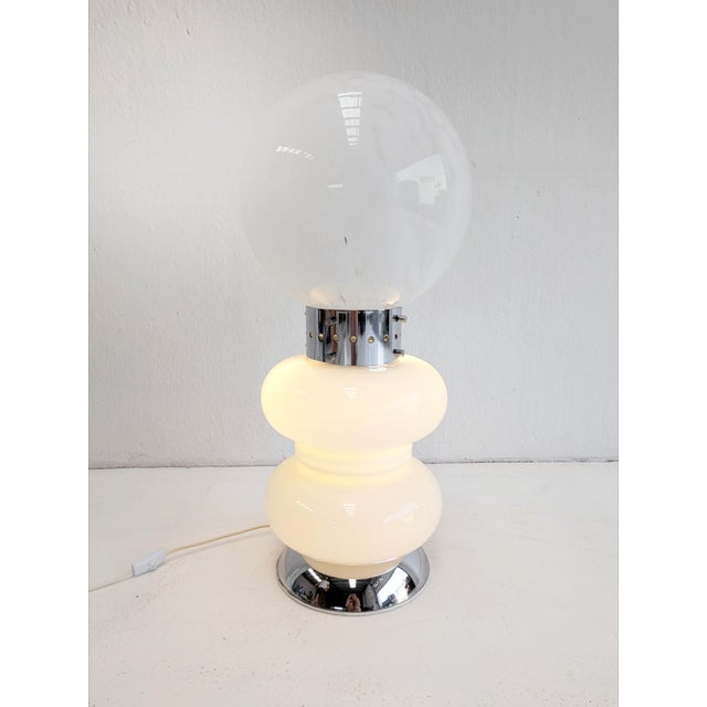 This striking vintage floor or table lamp, with playful proportions and a futuristic silhouette, is a true example of...