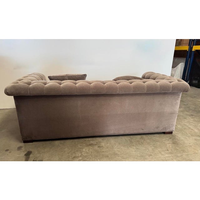 Chesterfield-style sofa with biscuit tufted arms and inside back. Nail head trim all over. 2 spring down seat cushions and...