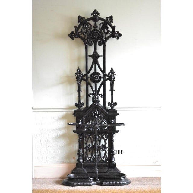 Very stylish English Victorian cast iron hall stand / coat stand in the manner of Christopher Dresser, having elaborate...