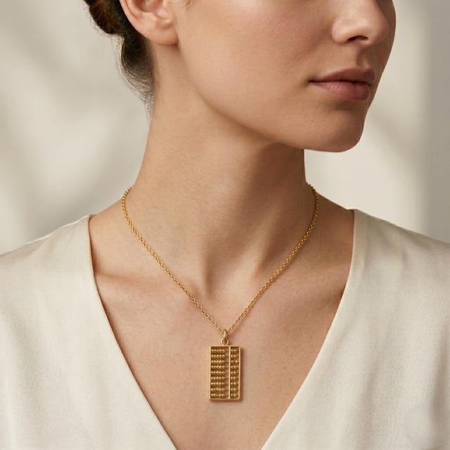 Discover the elegance of our 14k Yellow Gold Bead Framed Chinese Abacus Charm Pendant, a unique piece that beautifully...