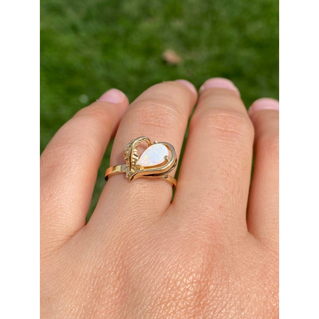 This stunning piece, known as The Australian Elegance, features a captivating Australian opal at its center. The pear cut...