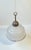 Art Deco or Bauhaus era styled hanging lamp featuring a frosted glass shade with black stripe and a patinated top in...
