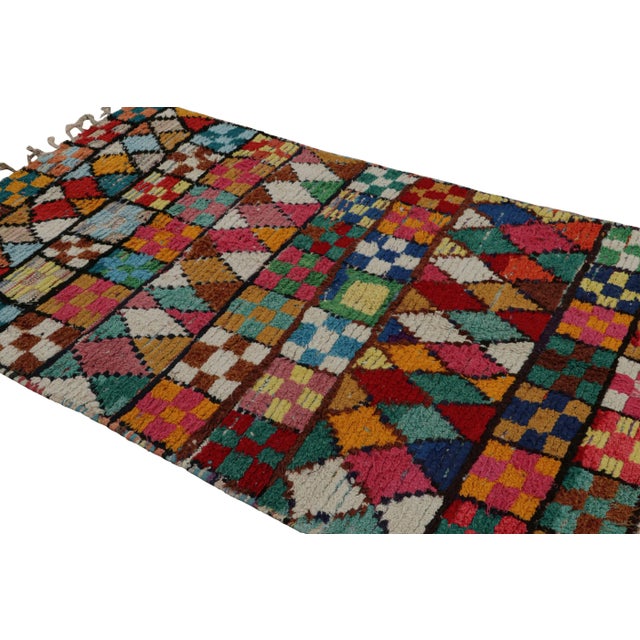 Hand-knotted in fabric in the titular technique, this vintage 5x8 Moroccan Boucherouite rug is believed to hail from the...