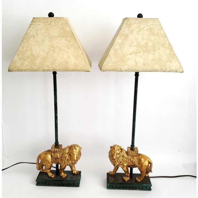 Offering a pair of RESTORED vintage gold leafed lion candlestick style table lamps, circa 1970s. These elegant...