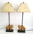 Offering a pair of RESTORED vintage gold leafed lion candlestick style table lamps, circa 1970s. These elegant...