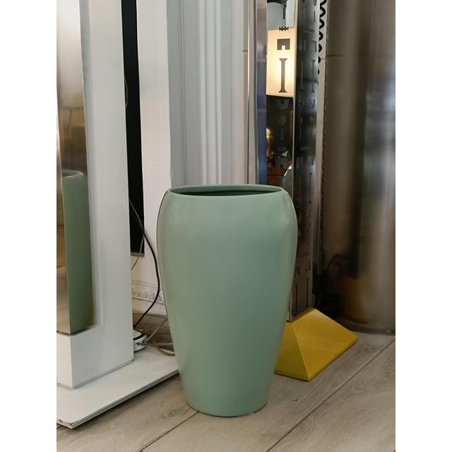 An extremely rare light green glazed ceramic vase, moulded by slip casting. The piece has a slender, ovoid shape that...