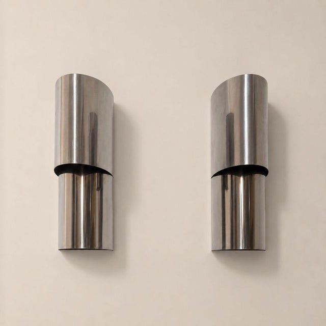 Pair of Italian wall lamps from the 1970s designed by Edera Radici and produced by SAGIM, crafted from curved steel. The...