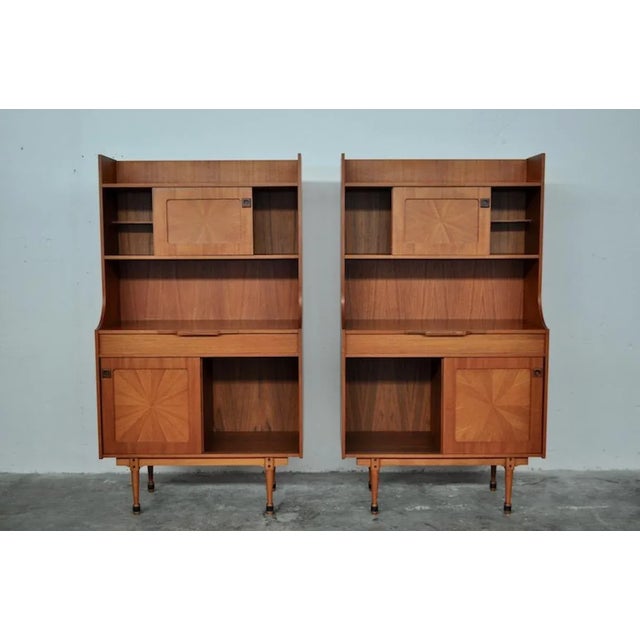 Rosewood with ebonized rosewood details. Original compass front hinges. Sliding doors.