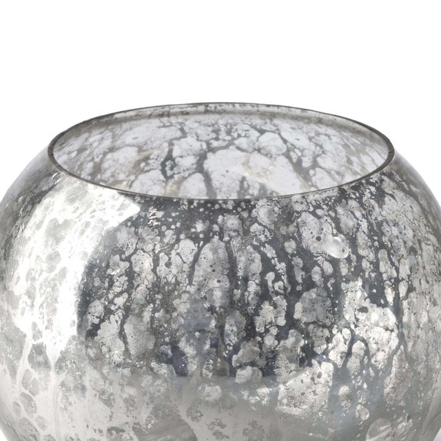 Wearing an Antique Mercury finish, this glass votive is a versatile decorative accent. Place tea candles inside for a warm...