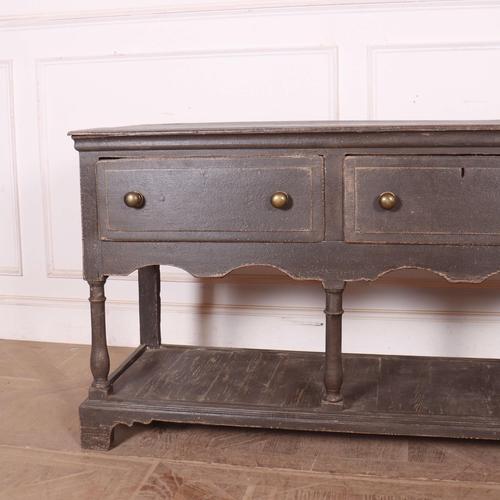 Early 18th C painted oak potboard dresser base. 1740 This piece is designed in the style of the selected designer and/or...