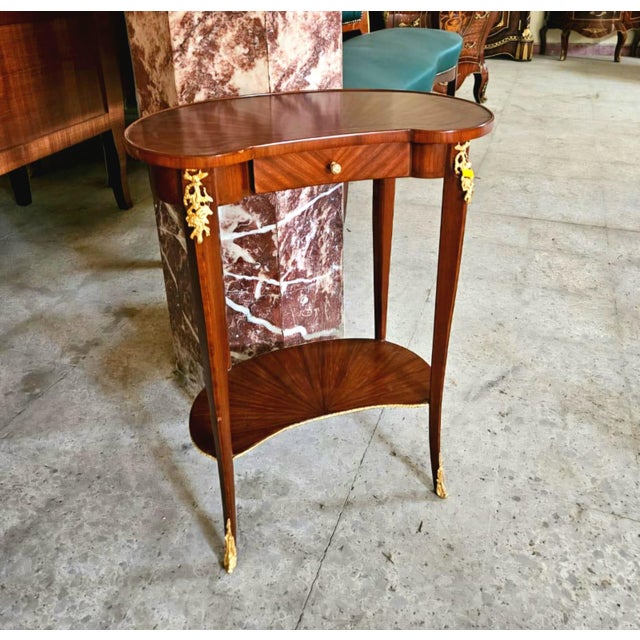 This French style wood side table is a luxurious statement piece that brings timeless elegance and refined craftsmanship...